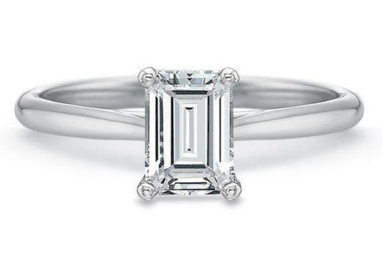 a white gold solitaire engagement ring with an emerald cut center diamond a white gold solitaire engagement ring with an emerald cut center diamond