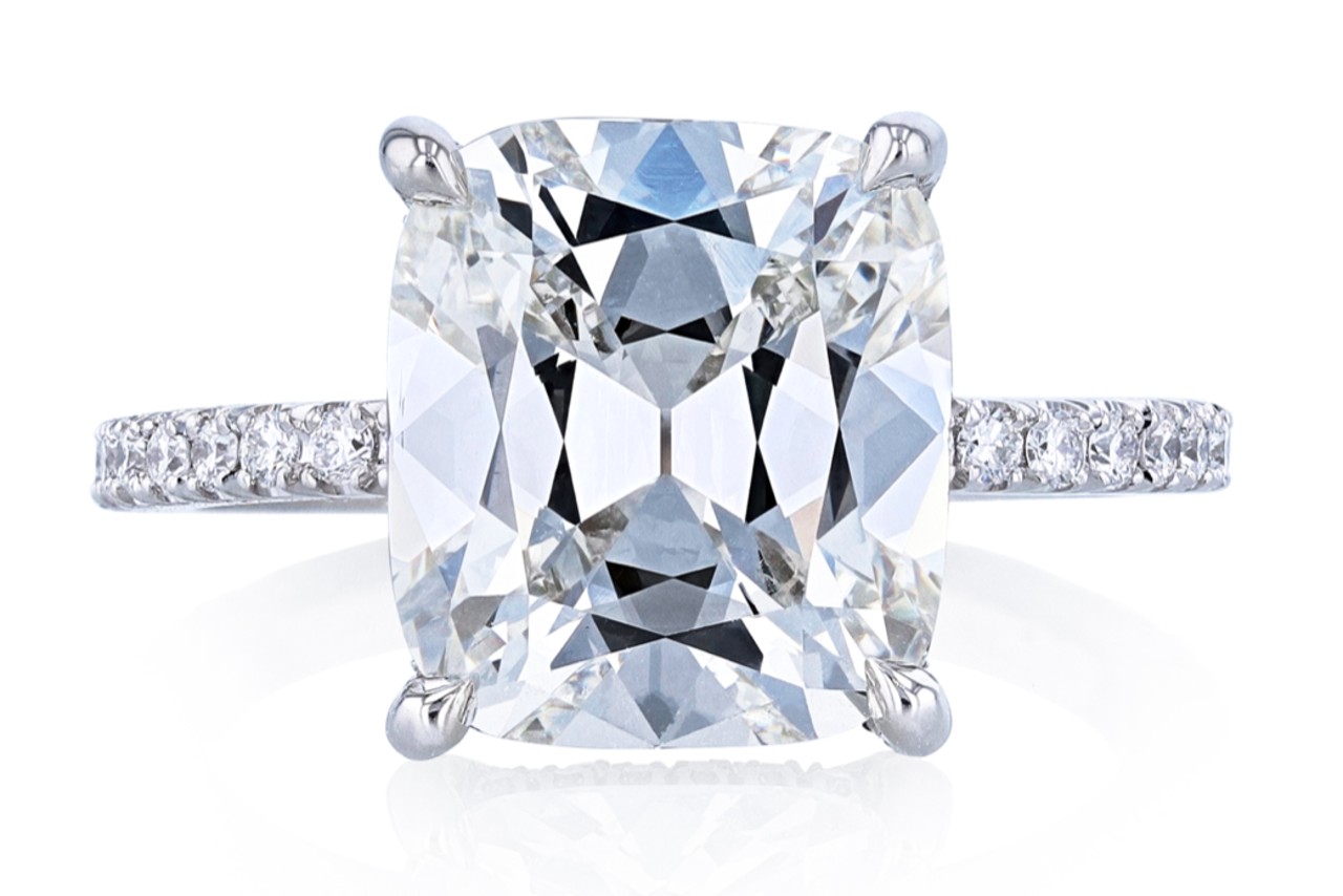 close up image of a platinum diamond engagement ring with a cushion cut center stone close up image of a platinum diamond engagement ring with a cushion cut center stone
