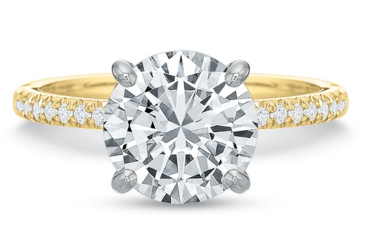 close up image of a yellow gold engagement ring with a round center diamond close up image of a yellow gold engagement ring with a round center diamond