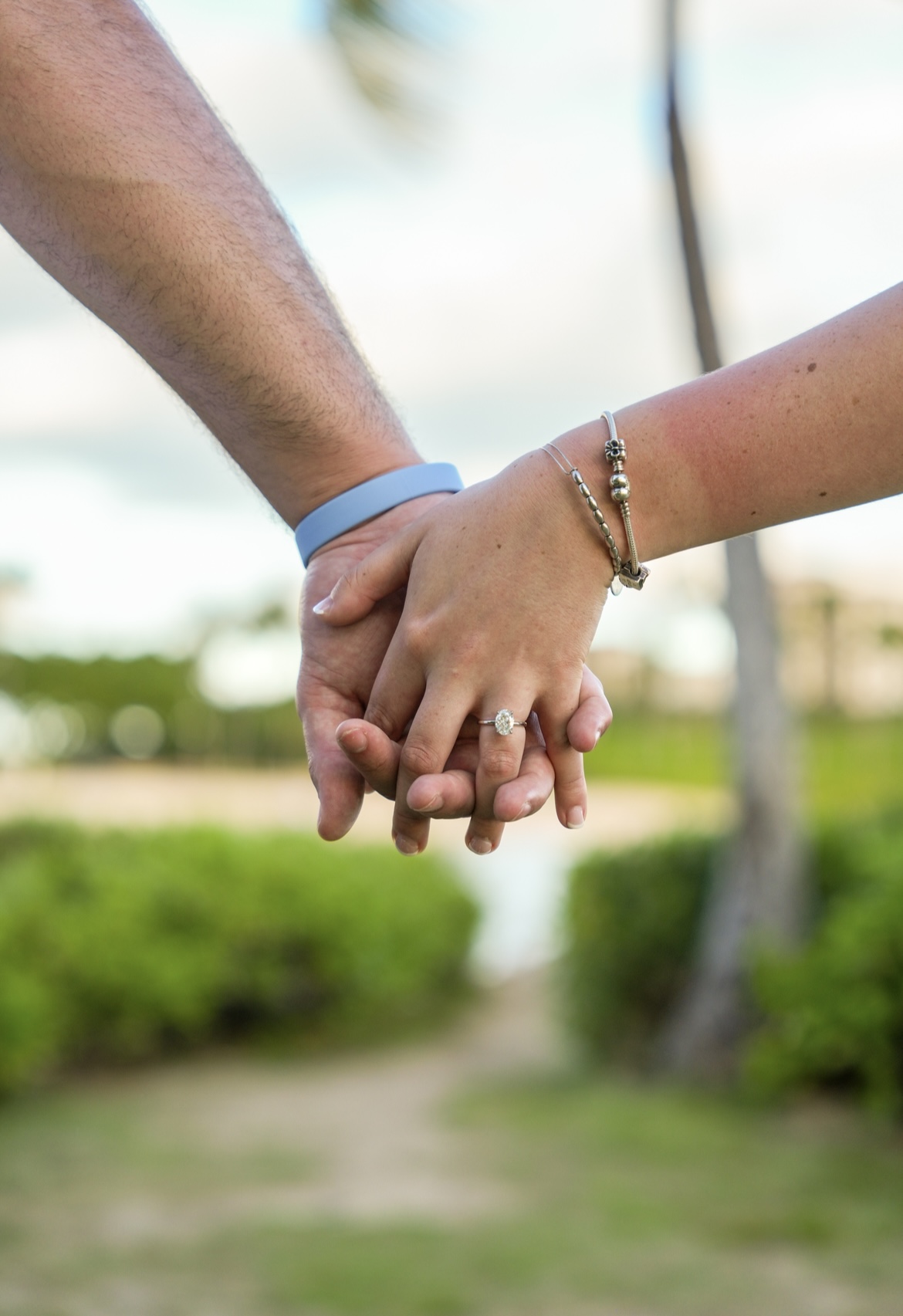 Julie and Matthew holding hands showing off the ring